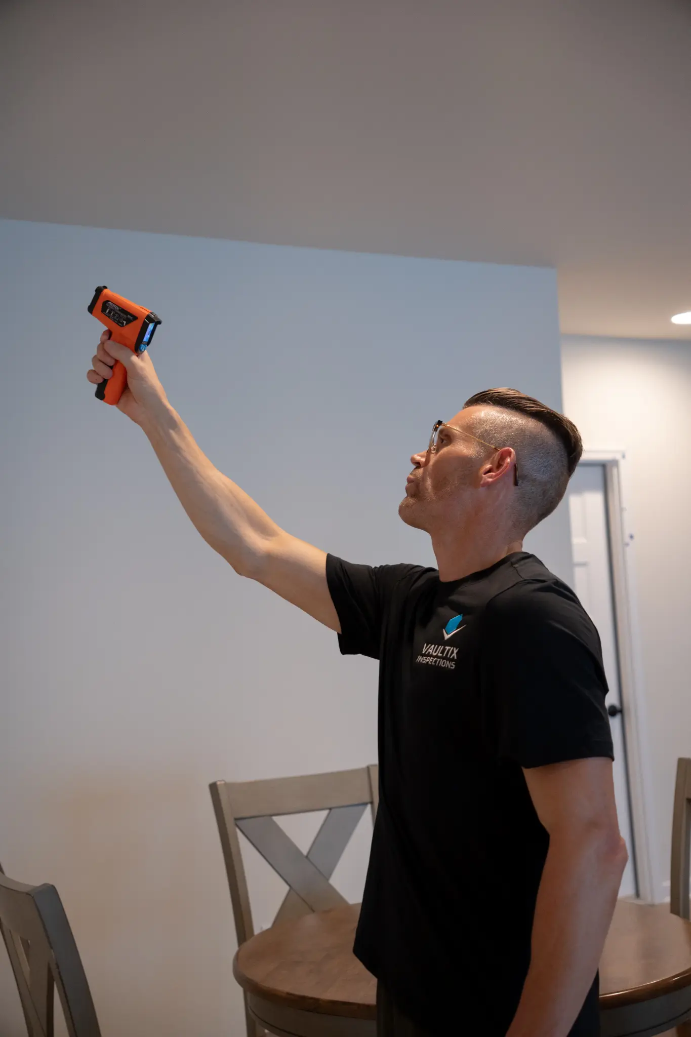 Inspector using equipment to examine an interior component